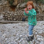 A child on a shingle beach