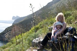 A woman and child resting in a meadow